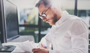 man at desk writing blog image machship