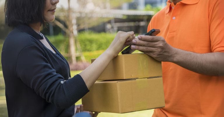 consumer receiving parcel from a courier