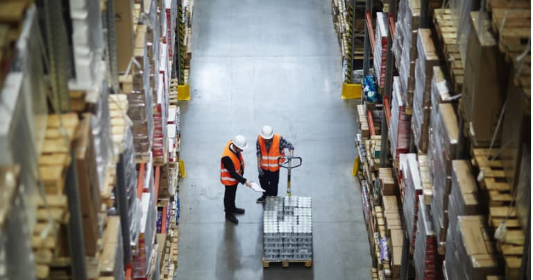 2 personnel on warehouse aisle with pallet truck