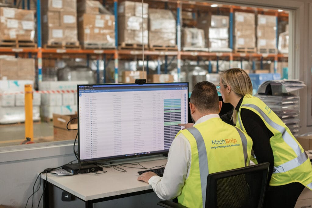 Warehouse staff using MachShip freight management software to track and manage carrier operations in real time.