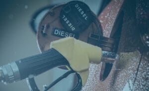 Close-up of a yellow diesel fuel nozzle, highlighting rising freight costs at the pump.